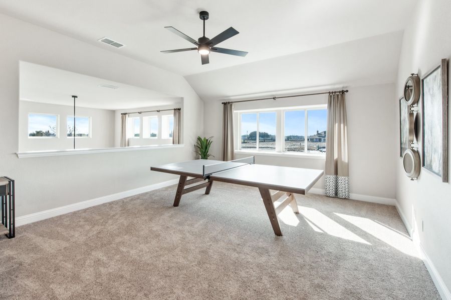 Bonus room with ping pong table, carpet flooring, vaulted ceiling, and ceiling fan Bonus room with ping pong table, carpet flooring, vaulted ceiling, and ceiling fan