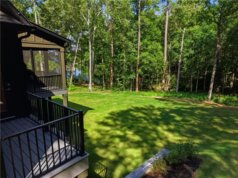 Mature trees frame a rolling green lawn bordered b