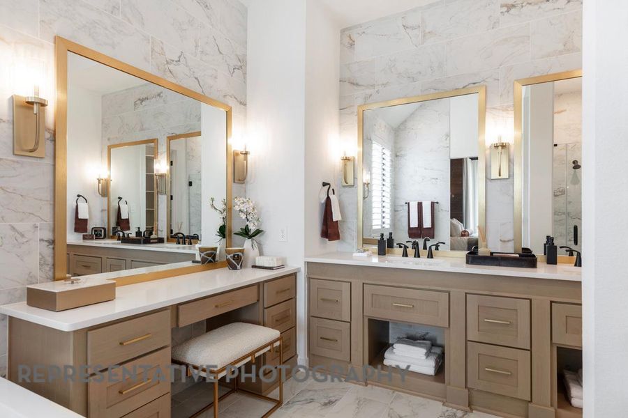 Full bathroom featuring vanity, marble finish floor, and a stall shower