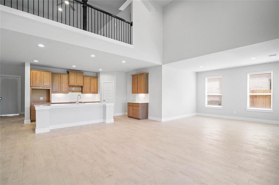 Another gorgeous view of the Family Room looking into the kitchen, the dining area, and view of the upstairs railing into game room.