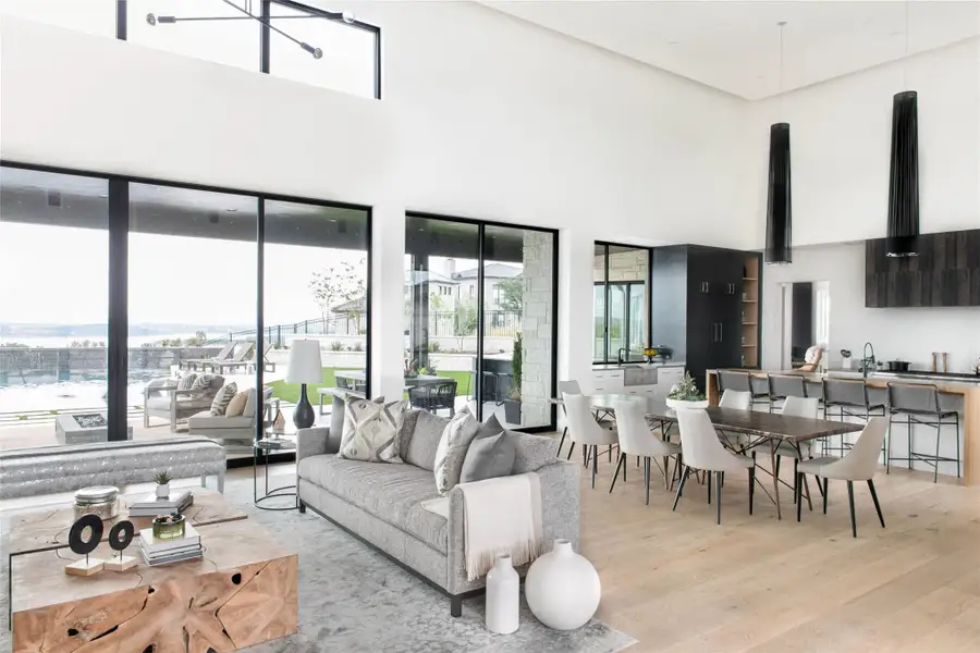 Living room featuring a towering ceiling and light wood-type flooring
