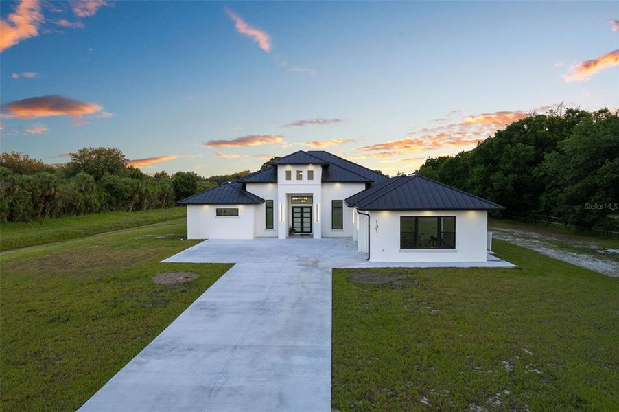 Front exterior of a new home in , Palm Bay, FL, highlighting curb appeal (Image 1). Front exterior of a new home in , Palm Bay, FL, highlighting curb appeal (Image 1).