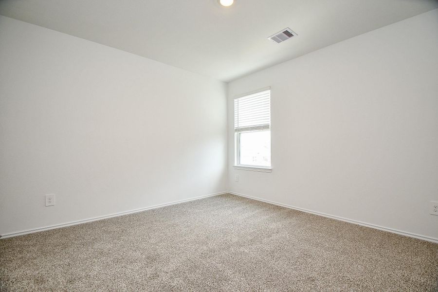 This room features a neutral color palette with plush carpet flooring and a window offering natural light. Ideal for a bedroom or home office. This room features a neutral color palette with plush carpet flooring and a window offering natural light. Ideal for a bedroom or home office.