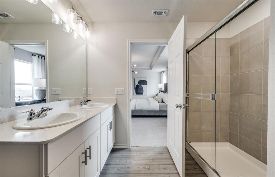 Elegant secondary Luxurious owner's bath complete with double sinks and a generous shower *Model representation