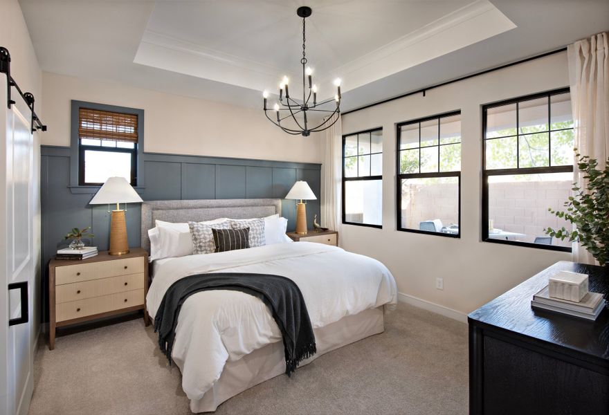 Primary suite with tray ceiling and chandelier Primary suite with tray ceiling and chandelier