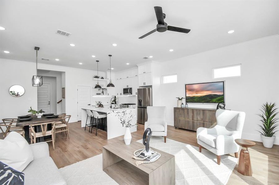 The kitchen seamlessly transitions into the elegantly appointed living room, boasting lofty 10-foot ceilings, abundant windows inviting natural light, and a sliding glass door providing access to the serene back patio.