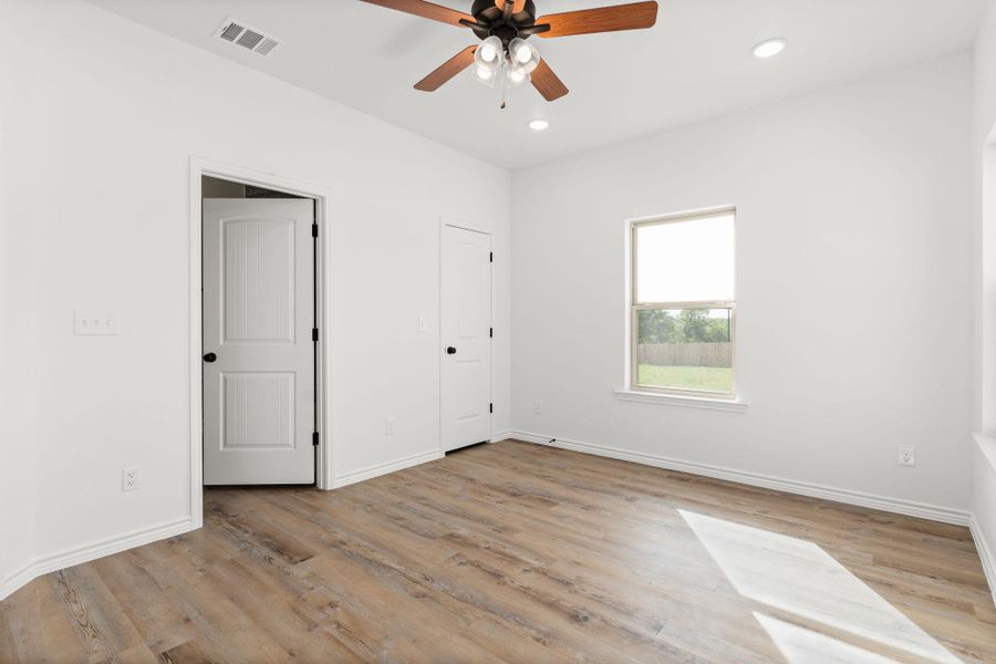 Unfurnished bedroom with wood finished floors, baseboards, visible vents, and recessed lighting Unfurnished bedroom with wood finished floors, baseboards, visible vents, and recessed lighting