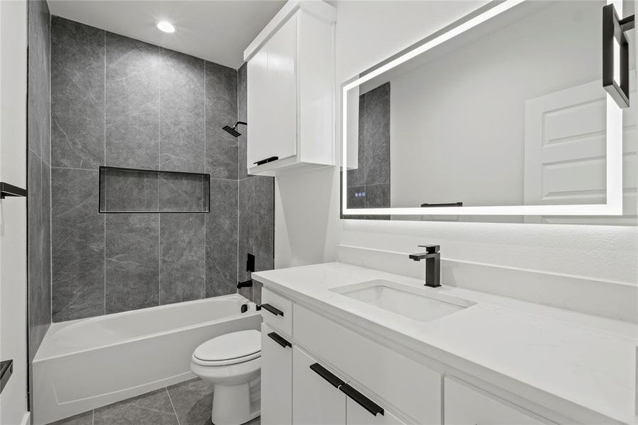 Bathroom featuring  shower combination, vanity, recessed lighting, and light tile patterned floors