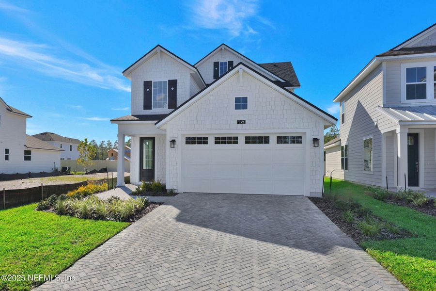 Front exterior of a new home in Seabrook Village at Seabrook, Ponte Vedra, FL, highlighting curb appeal (Image 2).