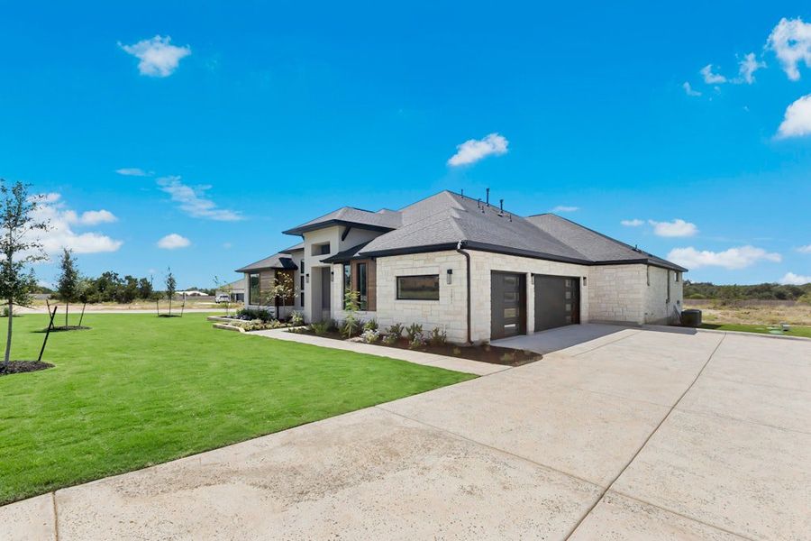 Front exterior of a new home in Leander Estates, Leander, TX, highlighting curb appeal (Image 21).