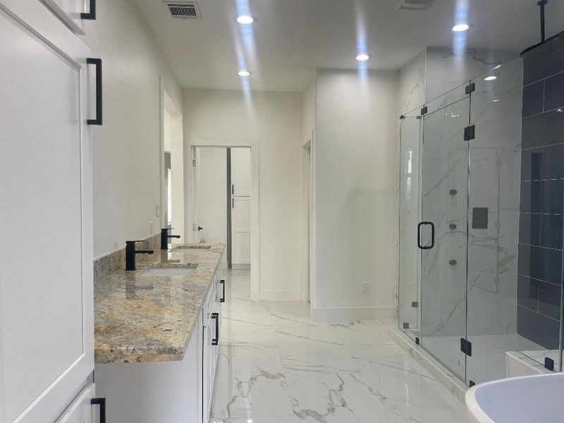 Primary bath w/ high end finishes such as marble floors
