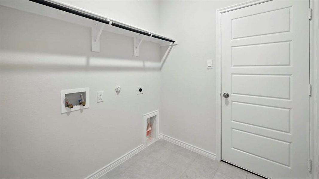 Laundry area featuring hookup for a gas dryer, washer hookup, and electric dryer hookup Laundry area featuring hookup for a gas dryer, washer hookup, and electric dryer hookup