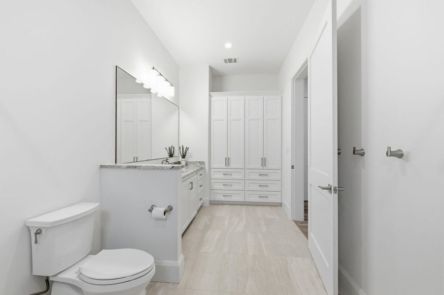 Full bathroom featuring vanity, a closet, and recessed lighting