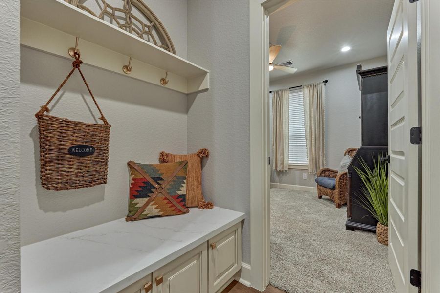 Built-in mudroom with seating, cabinets, and designer accents - located by the door leading to the garage- perfect for keeping life organized. Built-in mudroom with seating, cabinets, and designer accents - located by the door leading to the garage- perfect for keeping life organized.