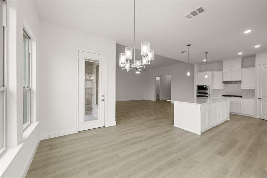 Kitchen with open floor plan, a chandelier, backsplash, recessed lighting, and appliances with stainless steel finishes Kitchen with open floor plan, a chandelier, backsplash, recessed lighting, and appliances with stainless steel finishes