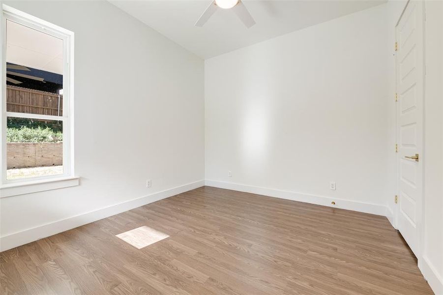 Empty room with wood finished floors and ceiling fan Empty room with wood finished floors and ceiling fan