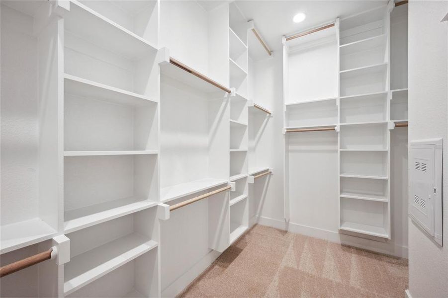 Walk in closet with light colored carpet