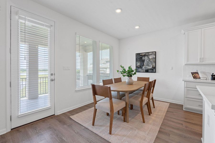 Dining room with wood finished floors, recessed lighting, and baseboards