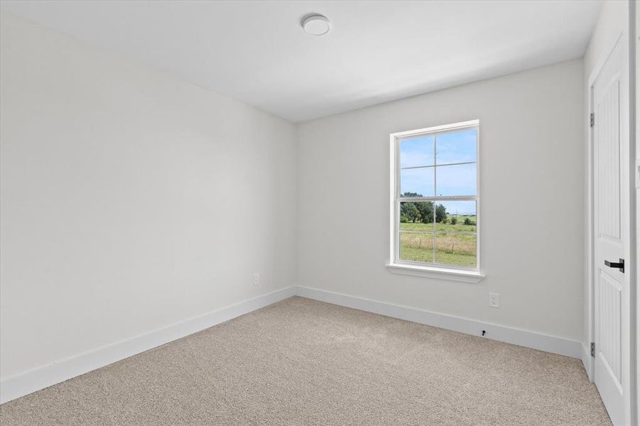 Unfurnished bedroom featuring baseboards and carpet flooring
