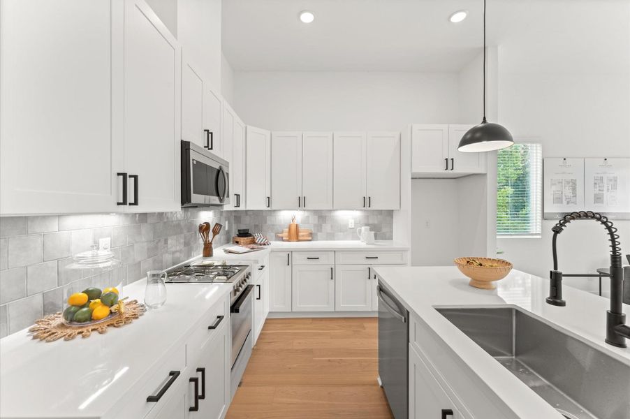 This beautifully designed kitchen showcases abundant cabinetry along the perimeter, offering generous storage for cookware, pantry items, and everyday essentials. The sleek kitchen island serves as both a functional prep space and a stylish centerpiece, featuring built-in cabinets and drawers that maximize organization. This beautifully designed kitchen showcases abundant cabinetry along the perimeter, offering generous storage for cookware, pantry items, and everyday essentials. The sleek kitchen island serves as both a functional prep space and a stylish centerpiece, featuring built-in cabinets and drawers that maximize organization.