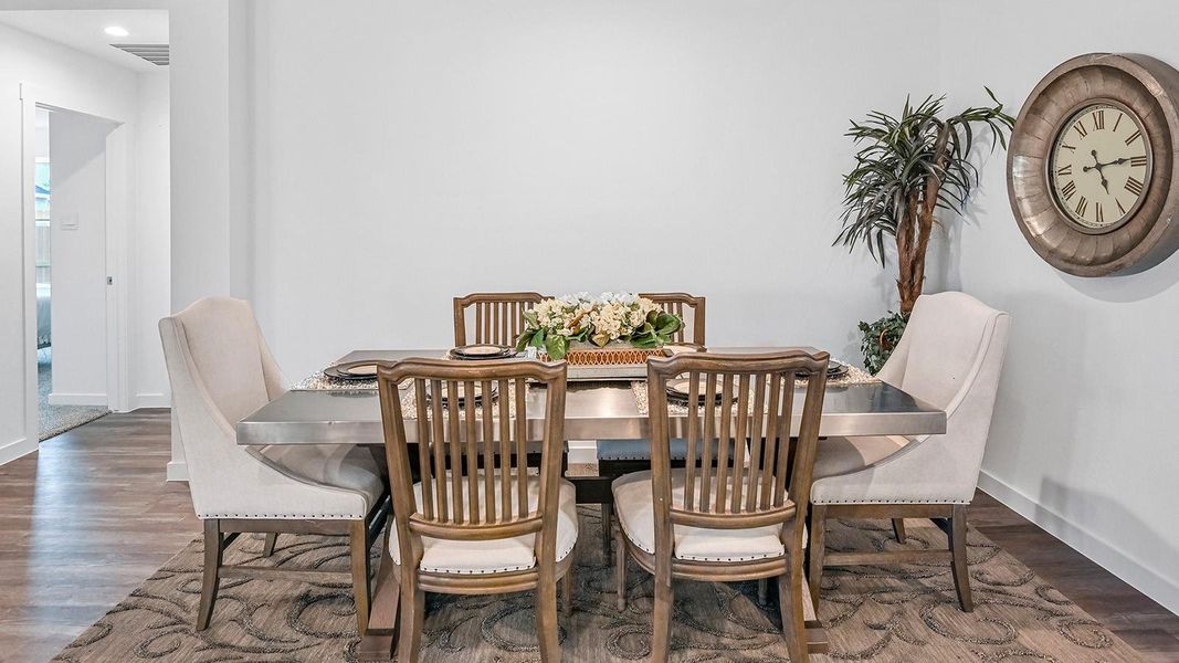 dining area with large windows, vinyl wood floors, and view of the backyard.