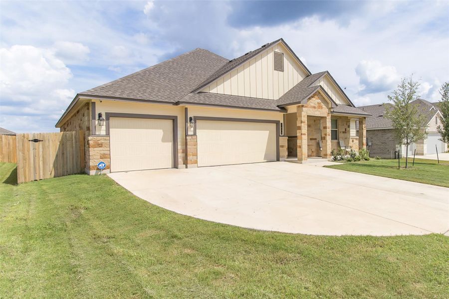 A well-maintained facade showcasing a two-car garage and a welcoming covered entrance. A well-maintained facade showcasing a two-car garage and a welcoming covered entrance.