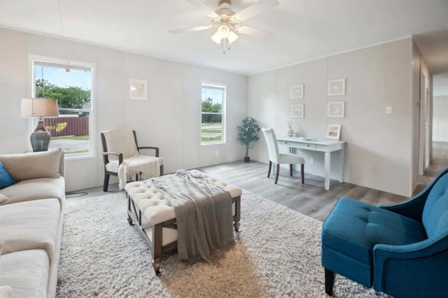 Living room with light hardwood / wood-style floors and ceiling fan