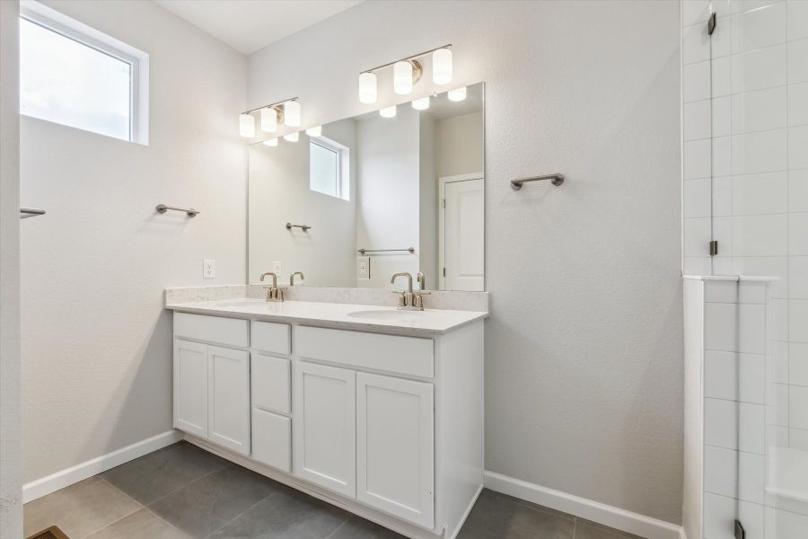 A bathroom with white cabinets. A bathroom with white cabinets.