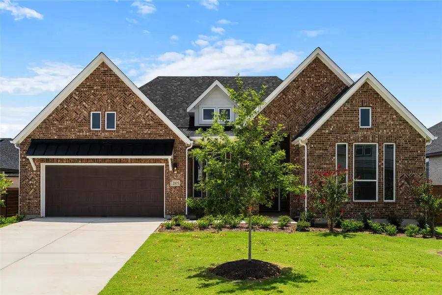 A classic brick facade with a neatly landscaped lawn create inviting curb appeal. A classic brick facade with a neatly landscaped lawn create inviting curb appeal.