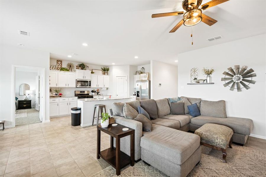 Living room with a ceiling fan and recessed lighting