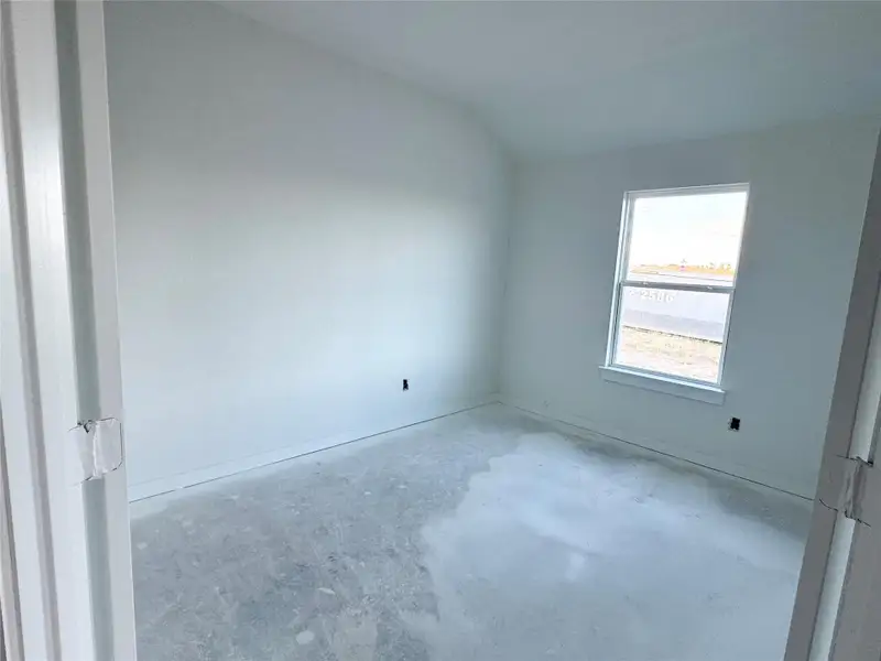 Unfurnished bedroom with unfinished concrete flooring and baseboards Unfurnished bedroom with unfinished concrete flooring and baseboards