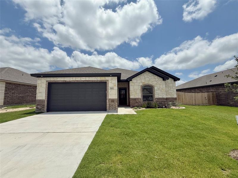 View of front of home featuring brick siding, concrete driveway, an attached garage, and stone siding