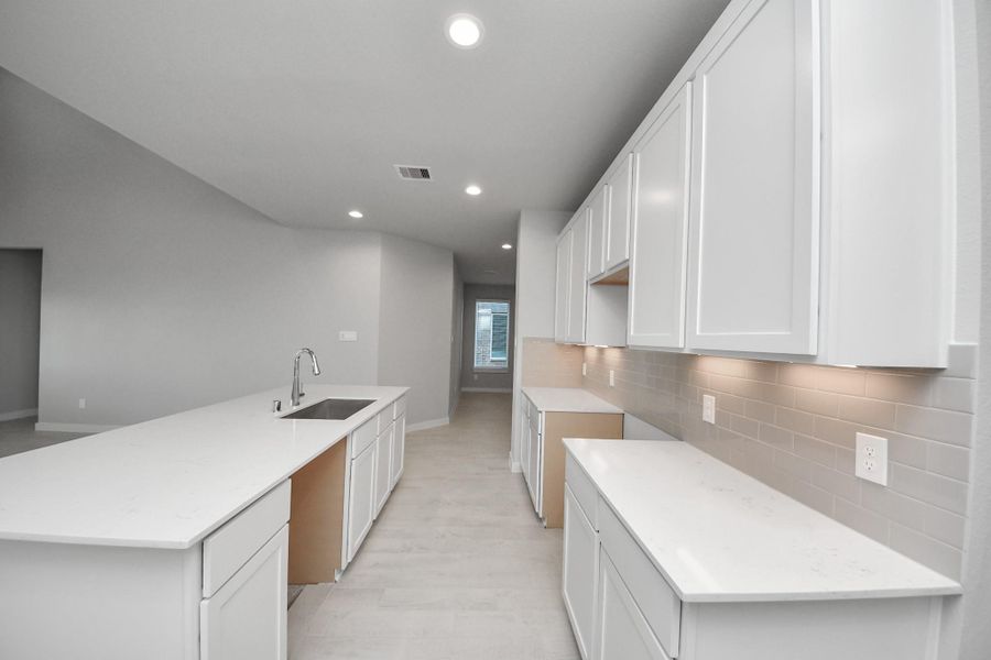 Experience the epitome of a dream kitchen in this generously spacious layout! Sample photo of completed home with similar floor plan. Actual colors and selections may vary.