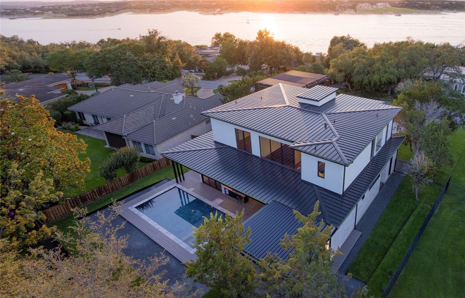 An aerial panorama reveals a contemporary home with sleek lines, a large pool, and a commanding waterfront vista. An aerial panorama reveals a contemporary home with sleek lines, a large pool, and a commanding waterfront vista.