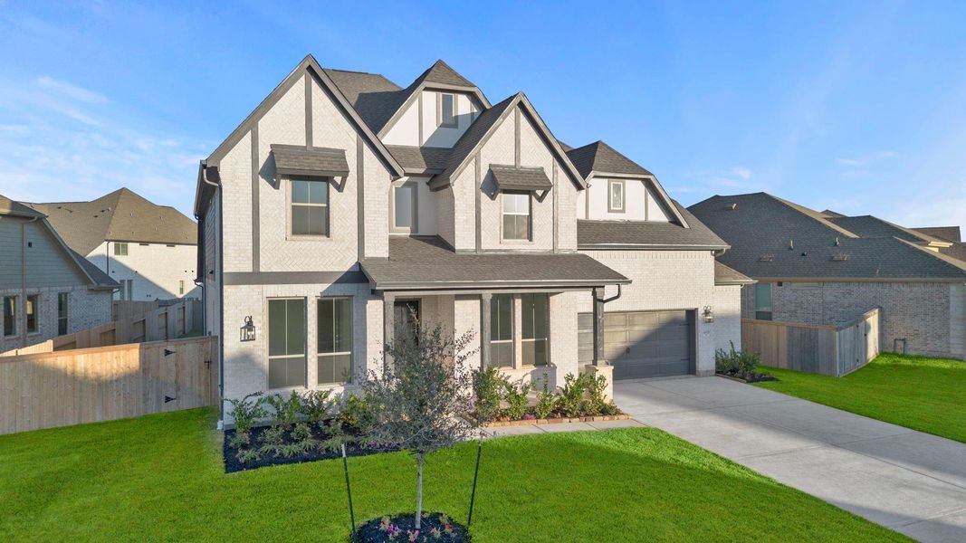 Front exterior of a new home in Coastal Point, League City, TX, highlighting curb appeal (Image 1).