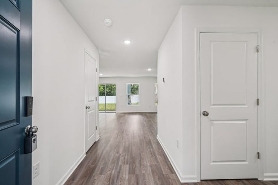 A hallway with white doors.