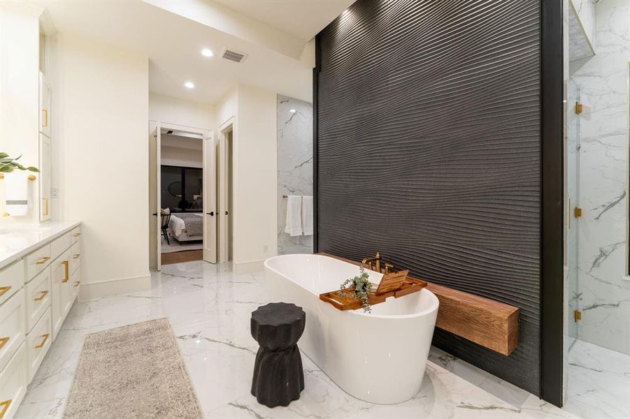 Bathroom featuring a tub, tile patterned flooring, and vanity