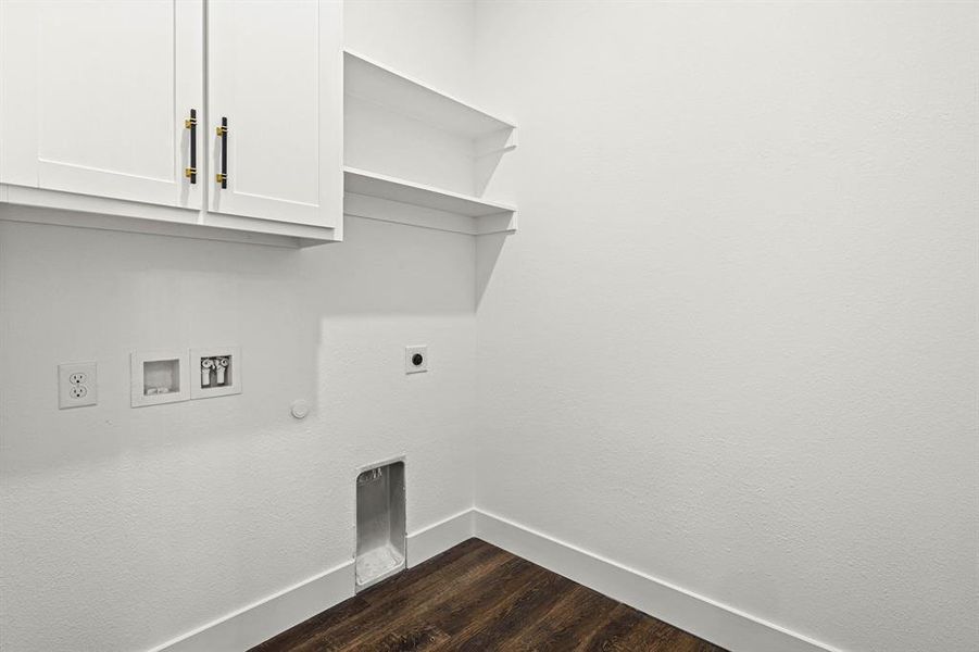 Laundry area with cabinet space, dark wood-type flooring, gas dryer hookup, electric dryer hookup, and baseboards