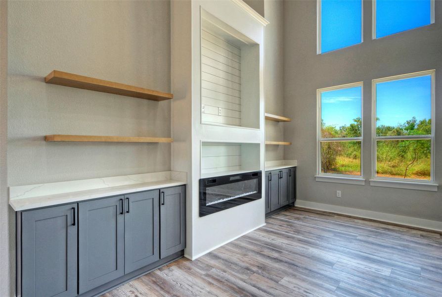Soaring ceilings and a modern fireplace wall with built-ins define this light-filled living space. Soaring ceilings and a modern fireplace wall with built-ins define this light-filled living space.