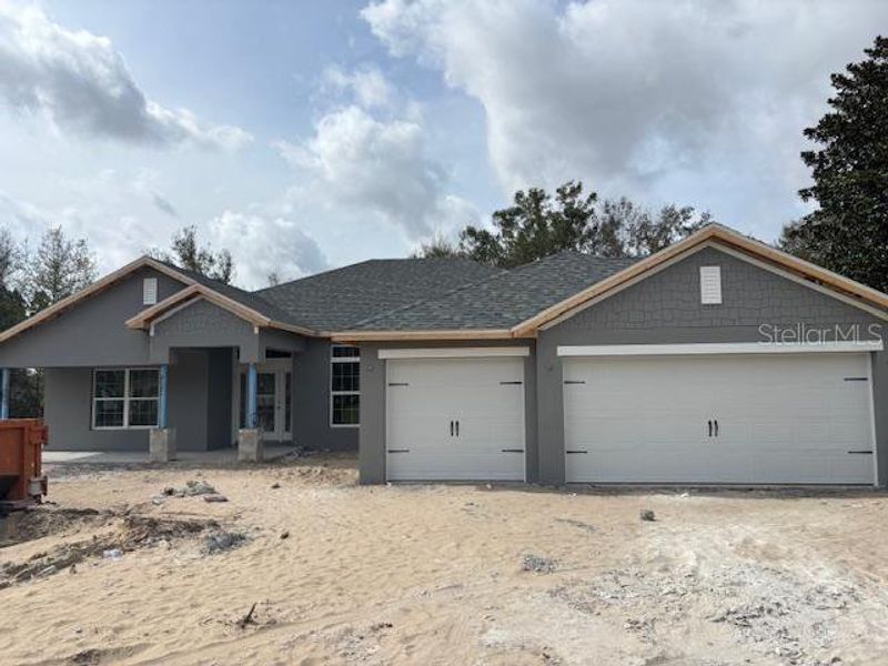 Front exterior of a new home in Juliette Falls, Dunnellon, FL, highlighting curb appeal (Image 1).