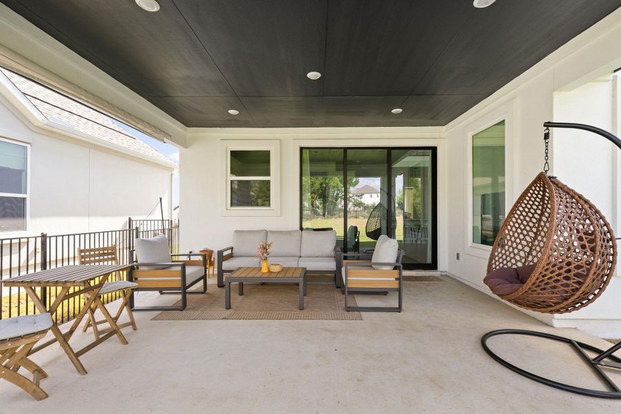 Covered patio featuring a dark paneled ceiling with recessed lighting