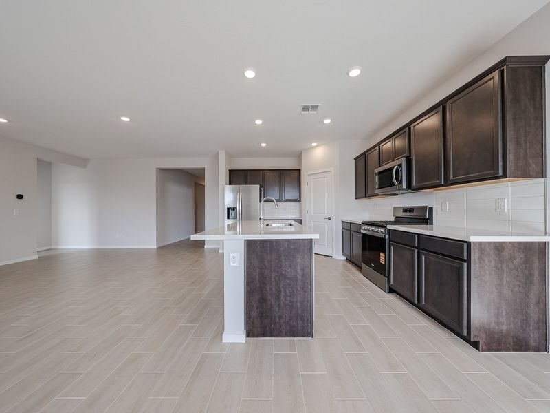 A kitchen with black cabinets. A kitchen with black cabinets.