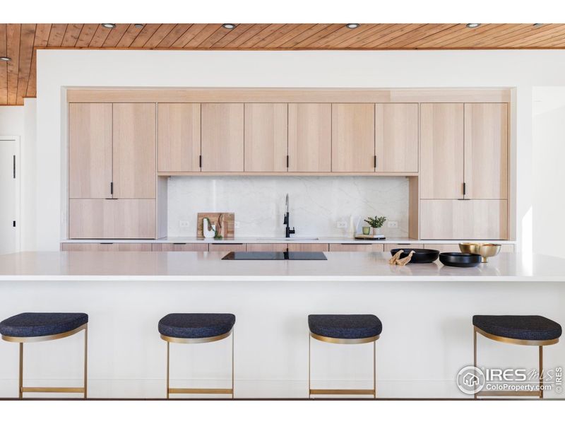 Elevate every culinary endeavor in the work-of-art open kitchen where custom whitewashed oak cabinetry and quartz countertops surround a fleet of Italian Smeg and Fisher & Paykel appliances. Elevate every culinary endeavor in the work-of-art open kitchen where custom whitewashed oak cabinetry and quartz countertops surround a fleet of Italian Smeg and Fisher & Paykel appliances.