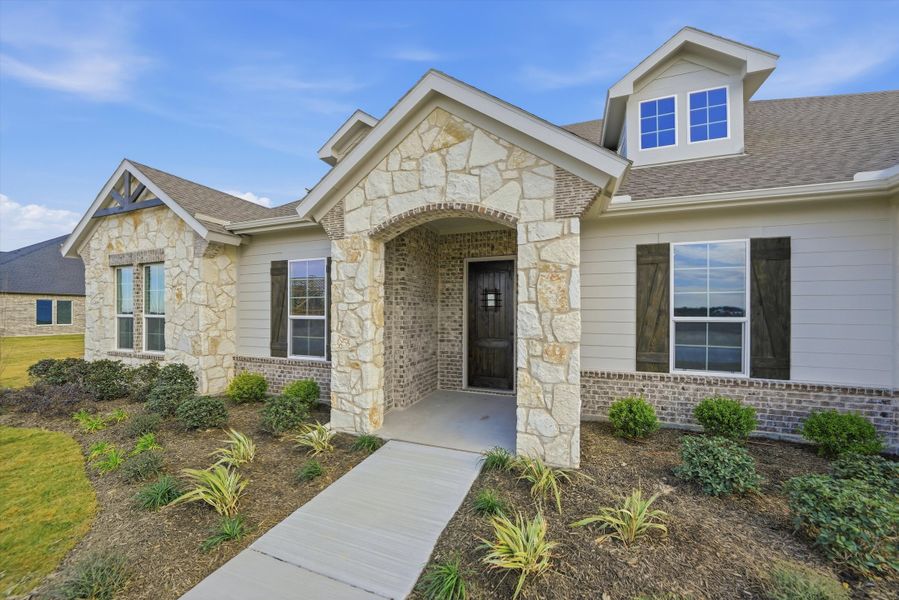 Front exterior of a new home in Eagle Ridge Estates, Weatherford, TX, highlighting curb appeal (Image 22).