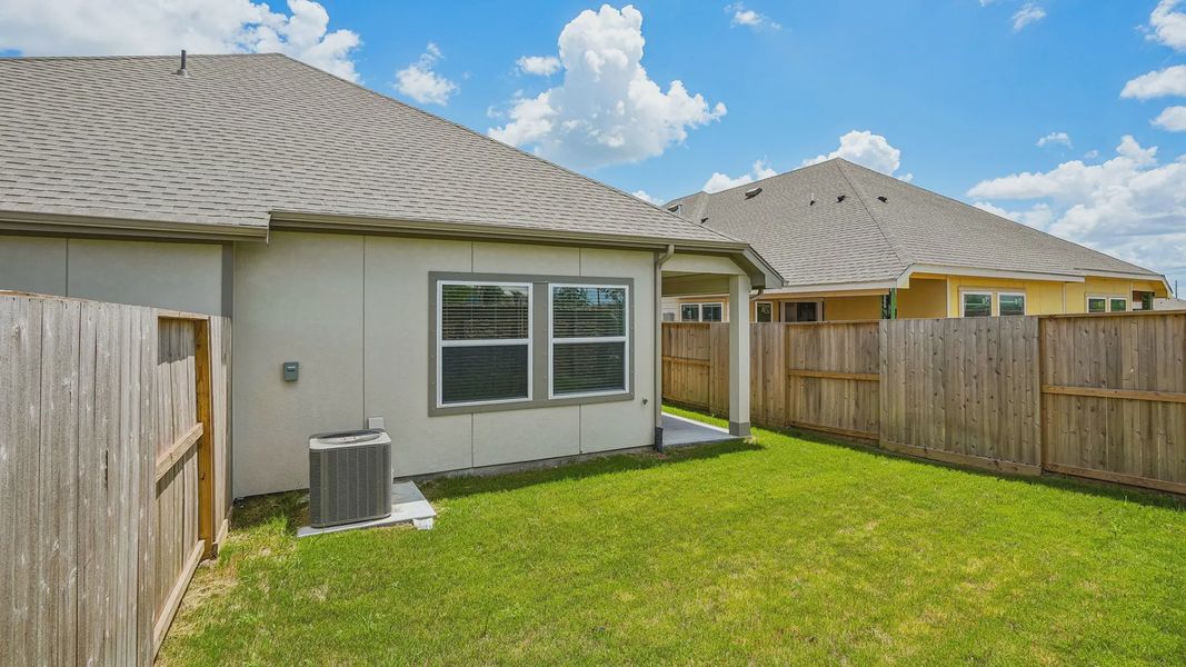 Exterior details and patio area of a home in Meridiana Townhomes, Iowa Colony (Image 17).
