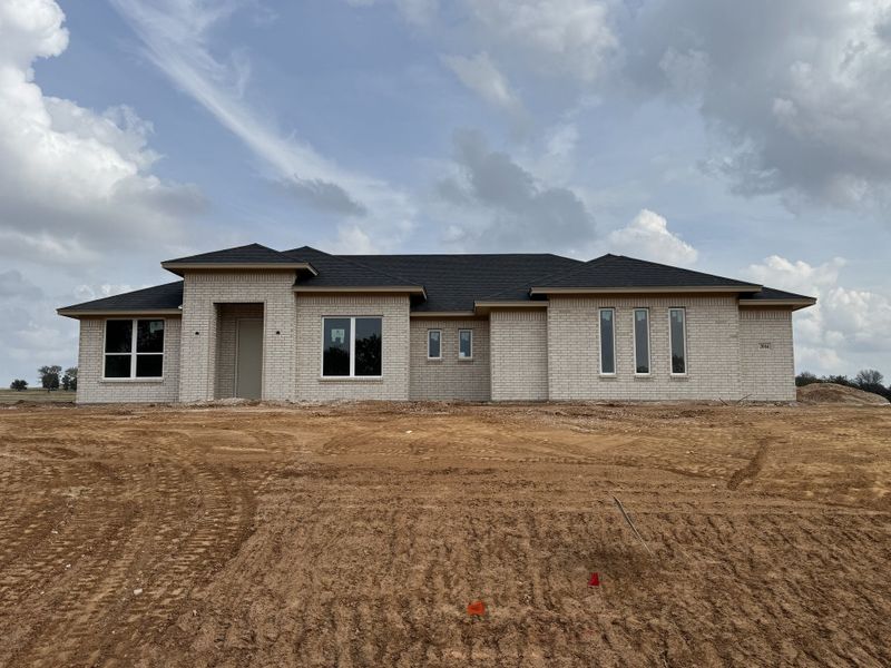 Front exterior of a new home in Taylor Ranch, Springtown, TX, highlighting curb appeal (Image 1).