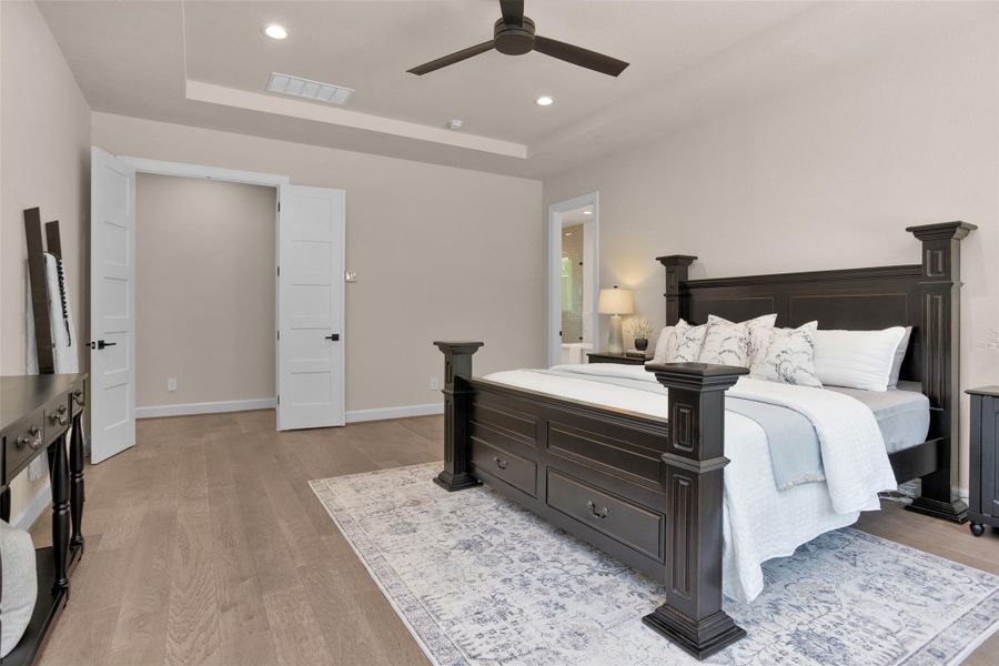 A set of double doors welcomes you into the primary suite while a separate entry leads to the luxurious en-suite bath for added comfort and privacy.