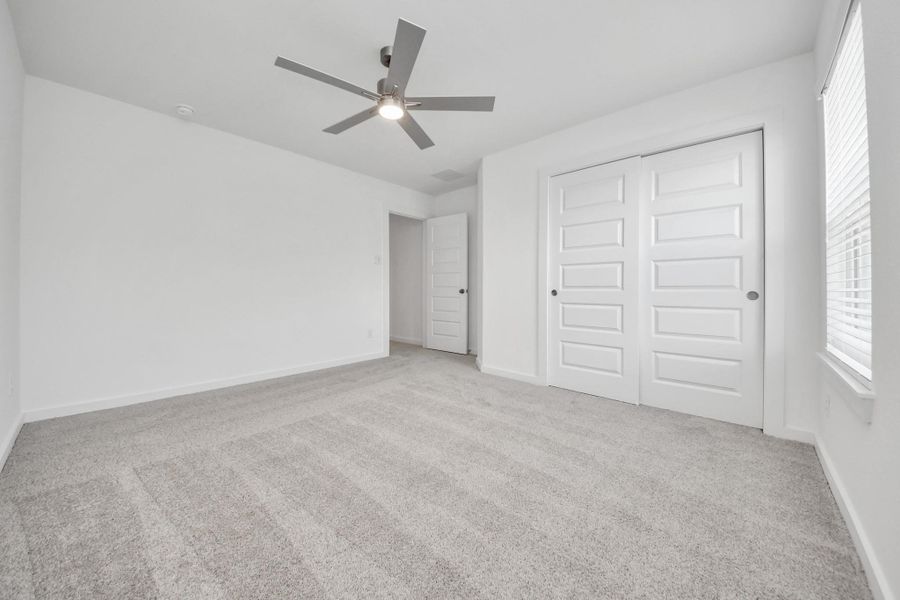Generously sized secondary bedrooms featuring spacious closets, soft and inviting carpeting underfoot, large windows allowing plenty of natural light, and the added touch of privacy blinds for your personal retreat. Sample photo of completed home with similar floor plan. Actual colors and selections may vary. Generously sized secondary bedrooms featuring spacious closets, soft and inviting carpeting underfoot, large windows allowing plenty of natural light, and the added touch of privacy blinds for your personal retreat. Sample photo of completed home with similar floor plan. Actual colors and selections may vary.