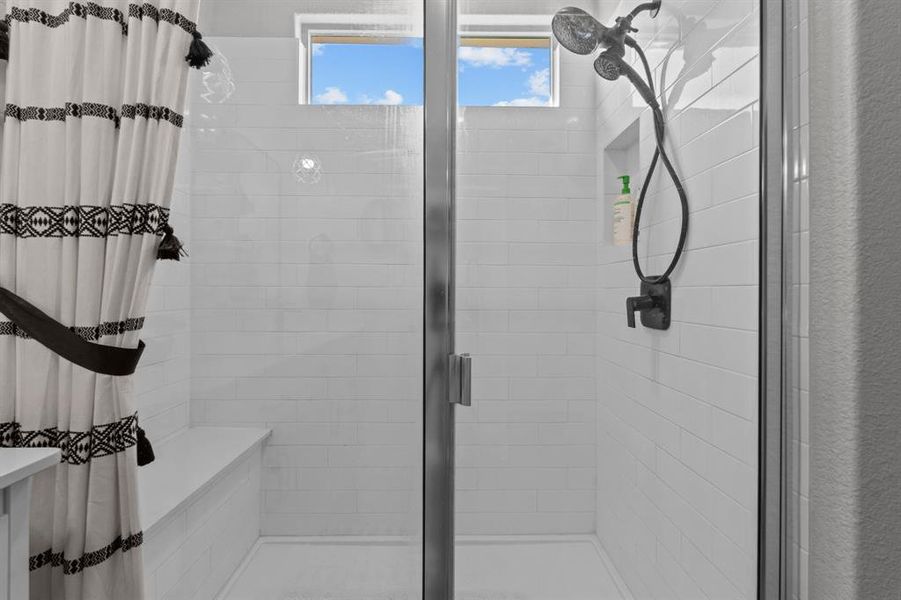 Bathroom featuring a shower with door