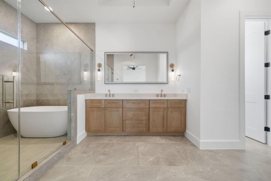 Primary bathroom features beautiful cabinetry, a soaking tub, and a spacious walk-in shower. Primary bathroom features beautiful cabinetry, a soaking tub, and a spacious walk-in shower.